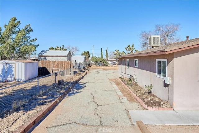 view of home's exterior featuring a storage unit and central air condition unit