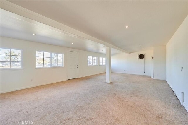 basement featuring a wealth of natural light and light carpet