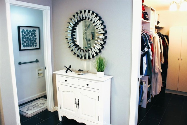 hall featuring dark tile patterned floors