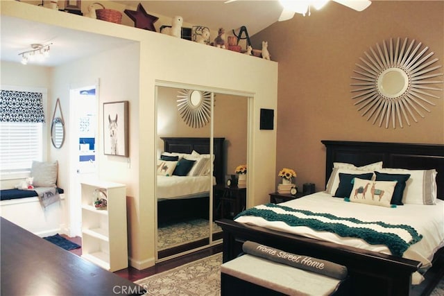 bedroom with dark wood-type flooring, ceiling fan, and a closet