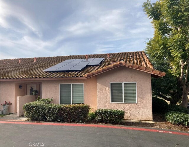 view of property exterior with solar panels