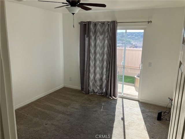 empty room with carpet, a ceiling fan, and baseboards