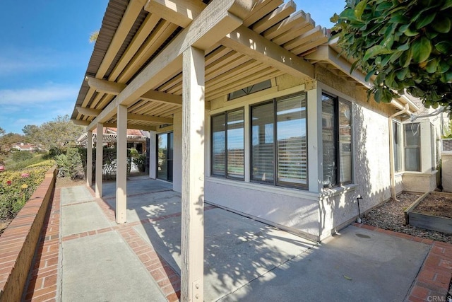 view of side of property with a patio