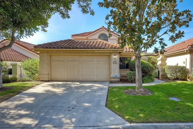 mediterranean / spanish-style house with a garage and a front yard