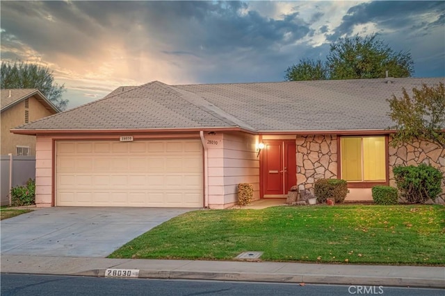 ranch-style home with a lawn and a garage