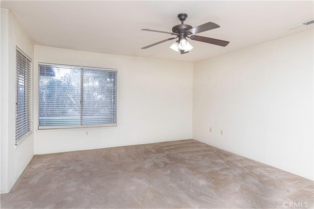 unfurnished room with ceiling fan and light colored carpet