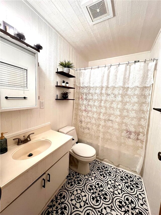 206 E Barker Blvd, Big Bear City, CA 92314 - bathroom featuring visible vents, vanity, toilet, wooden walls, and tile patterned floors