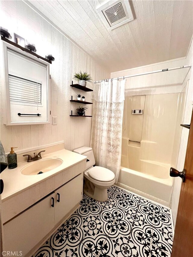 206 E Barker Blvd, Big Bear City, CA 92314 - bathroom featuring vanity, toilet, tile patterned floors, shower / bath combo with shower curtain, and visible vents