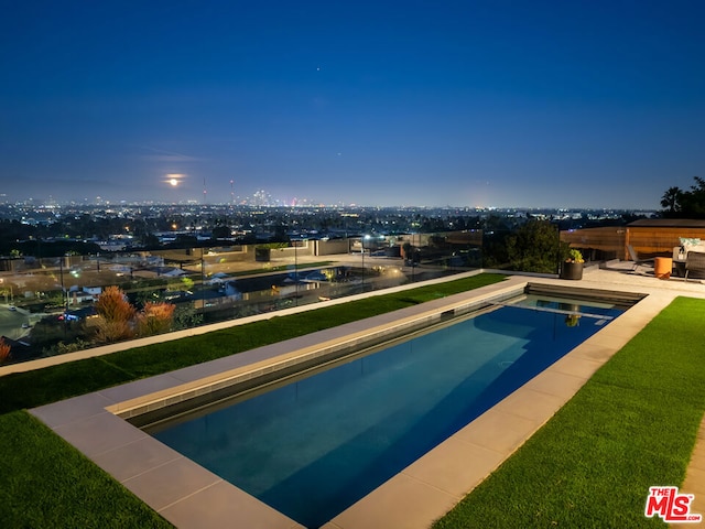 view of pool at dusk