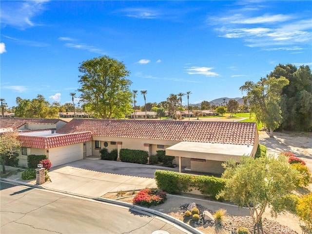 view of front facade featuring a mountain view and a garage