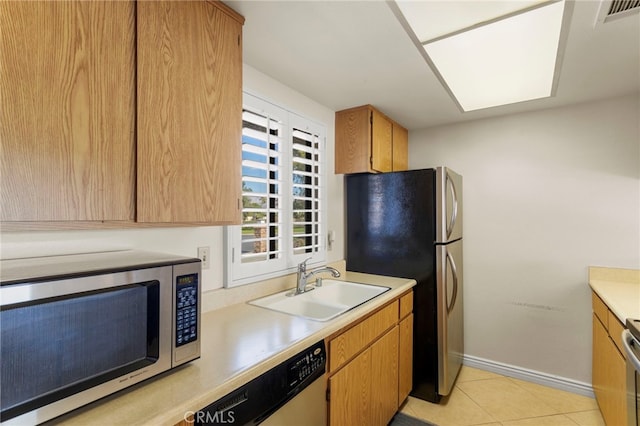 kitchen featuring light tile patterned flooring, sink, and appliances with stainless steel finishes