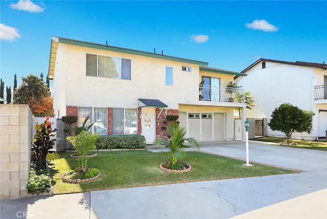 view of front of home with a garage, a balcony, and a front yard