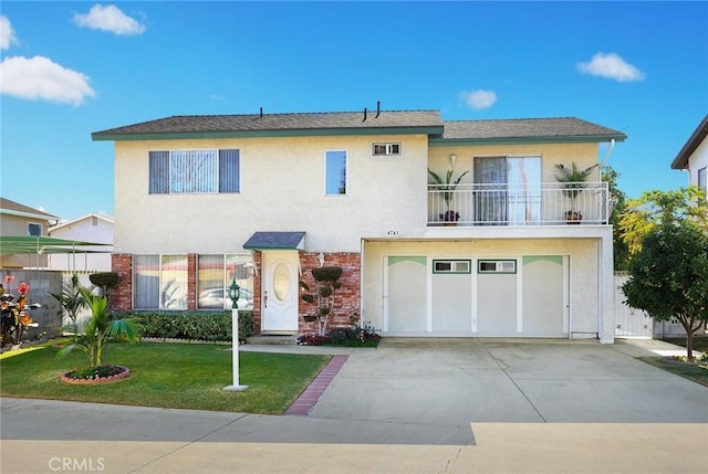 view of front of house featuring a balcony, a front lawn, and a garage