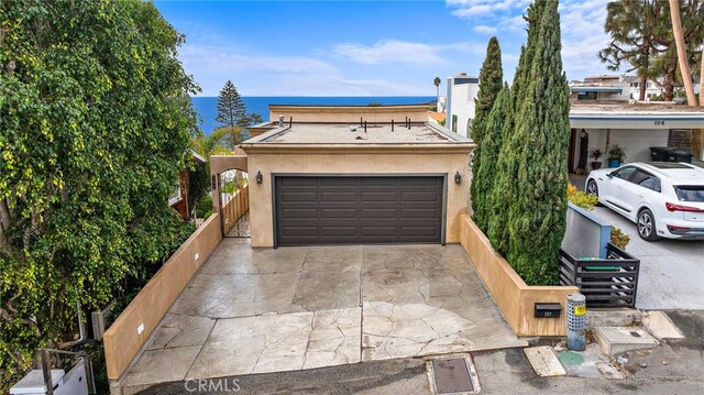 view of front of property featuring a garage and a water view