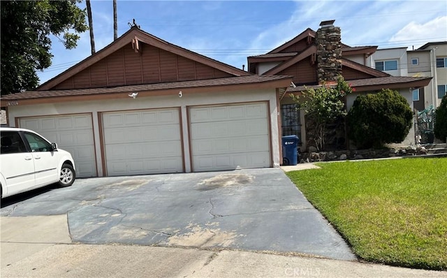 view of front of house featuring a garage and a front lawn