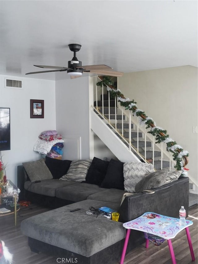 living room featuring wood-type flooring and ceiling fan