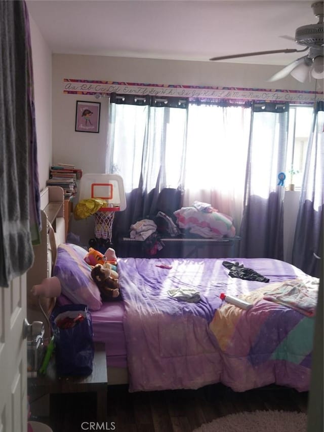 bedroom featuring hardwood / wood-style floors and ceiling fan