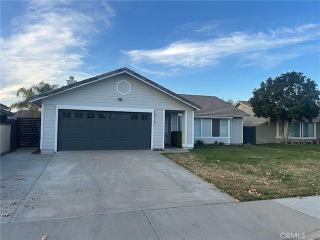 single story home featuring a garage and a front lawn