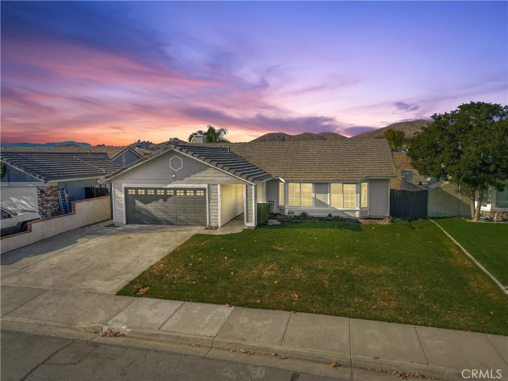 ranch-style home with a lawn and a garage