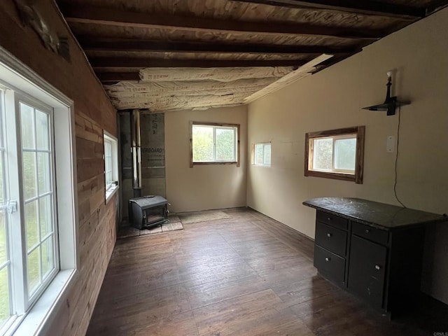 interior space with wood ceiling, plenty of natural light, a wood stove, and dark hardwood / wood-style floors