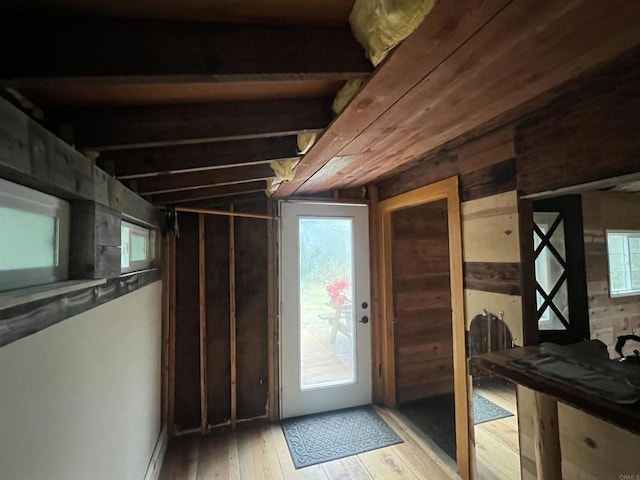 interior space featuring light wood-type flooring, vaulted ceiling, and plenty of natural light