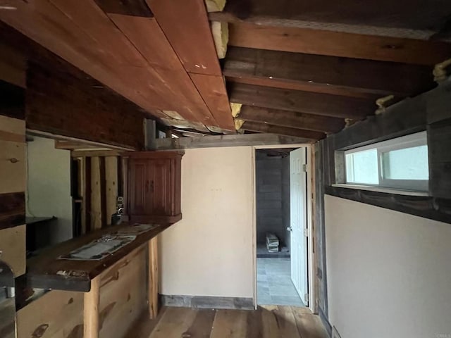 basement featuring light wood-type flooring and wood ceiling