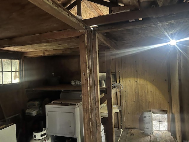 basement with washer / dryer and wood walls