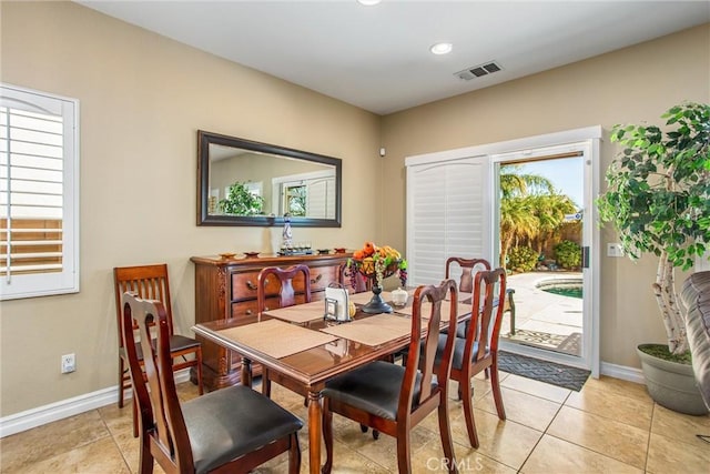 dining room featuring plenty of natural light, visible vents, and baseboards