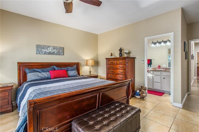 bedroom with light tile patterned floors, ceiling fan, baseboards, and connected bathroom