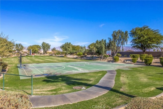 view of home's community featuring community basketball court and a yard