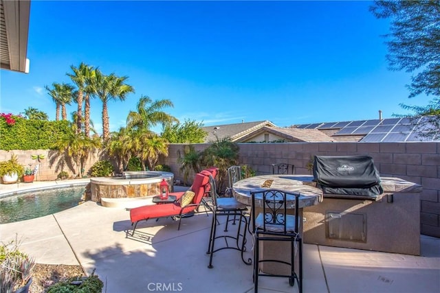 view of patio with outdoor dining space, a fenced backyard, area for grilling, and an in ground hot tub