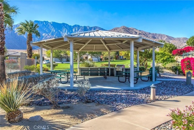 view of property's community featuring a gazebo, fence, and a mountain view