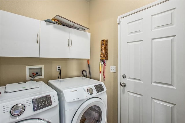 washroom with cabinet space and independent washer and dryer