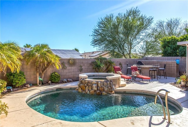 view of pool featuring a fenced in pool, a patio, a fenced backyard, outdoor dry bar, and an in ground hot tub