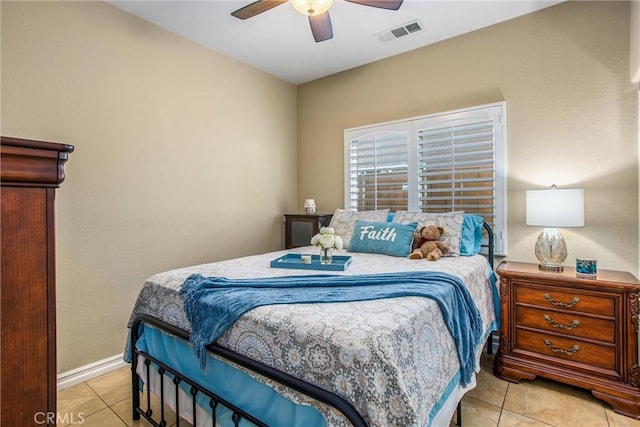 bedroom with ceiling fan, tile patterned flooring, visible vents, and baseboards