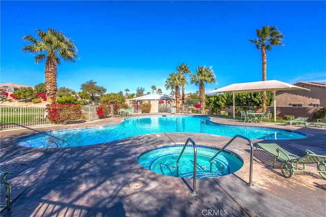 community pool with a community hot tub, a patio area, and fence