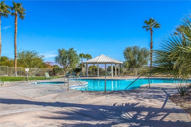 community pool featuring a patio area, fence, and a gazebo