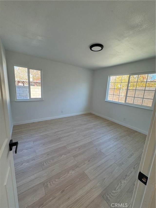 spare room featuring light hardwood / wood-style floors