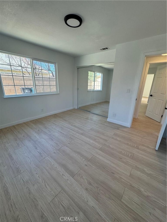 spare room with light hardwood / wood-style flooring