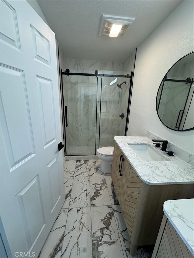 bathroom featuring vanity, toilet, and walk in shower