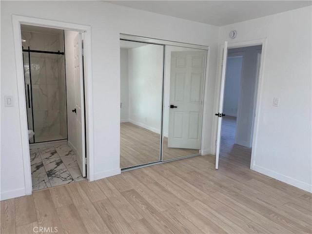 unfurnished bedroom featuring a closet and light hardwood / wood-style floors