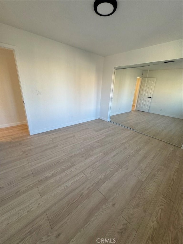 unfurnished room with light hardwood / wood-style flooring