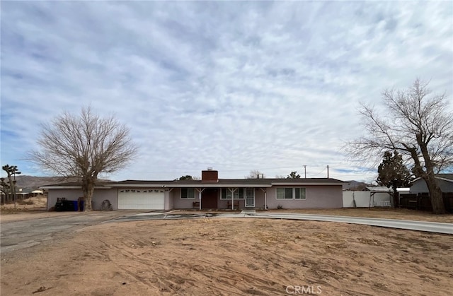 ranch-style home featuring a garage