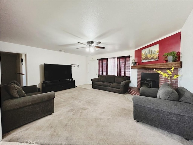 living room featuring ceiling fan, carpet, and a wood stove