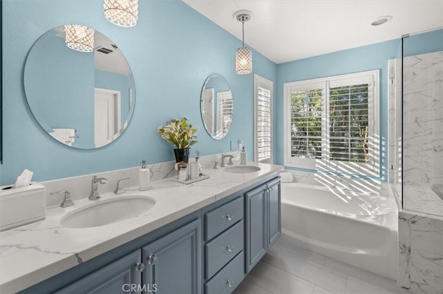 bathroom featuring vanity, tile patterned flooring, and a washtub