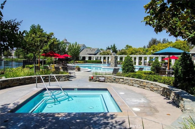 view of swimming pool with a patio area and a community hot tub