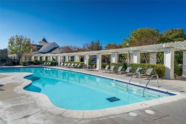 view of pool with a pergola and a patio