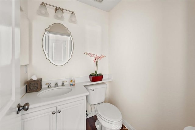 bathroom featuring toilet and vanity