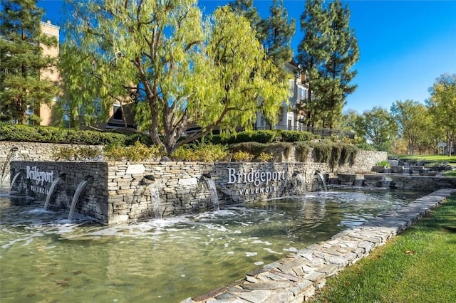 community / neighborhood sign with a water view