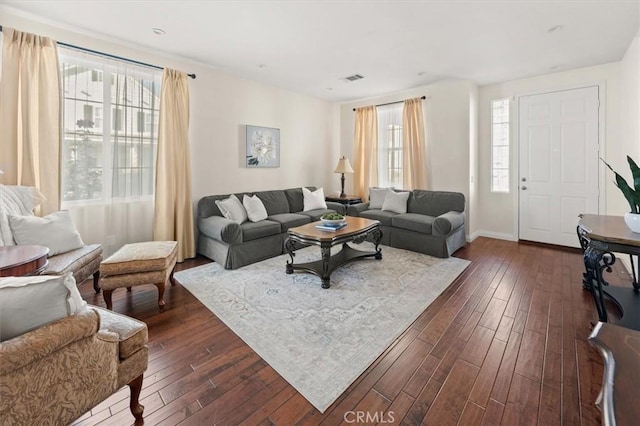 living room featuring plenty of natural light and dark hardwood / wood-style floors